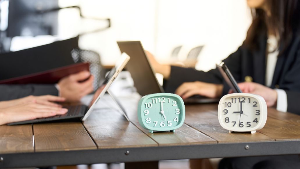 目覚まし時計と働く人